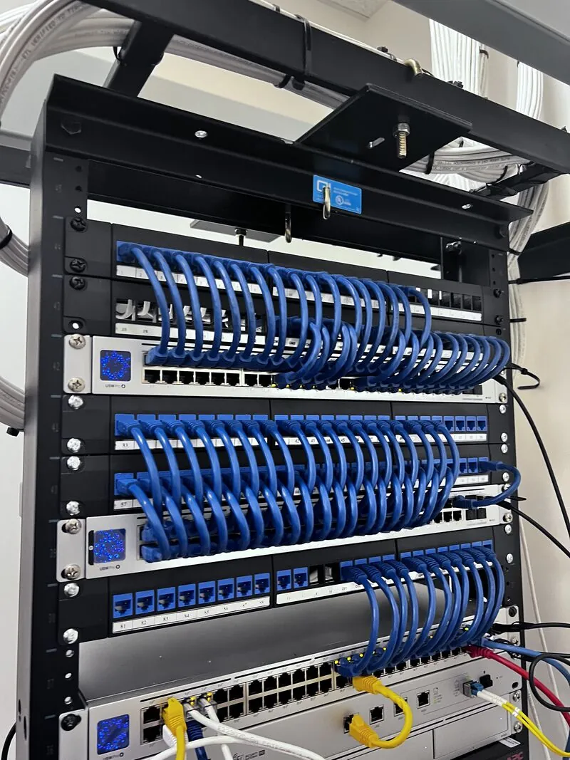 Access Cabling installation — high-density rack buildout with vertical cable management