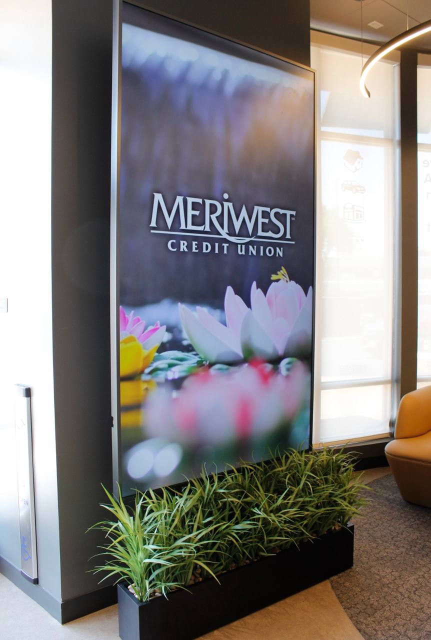 One of two vertically mounted 98-inch commercial displays in the Meriwest Credit Union Milpitas lobby