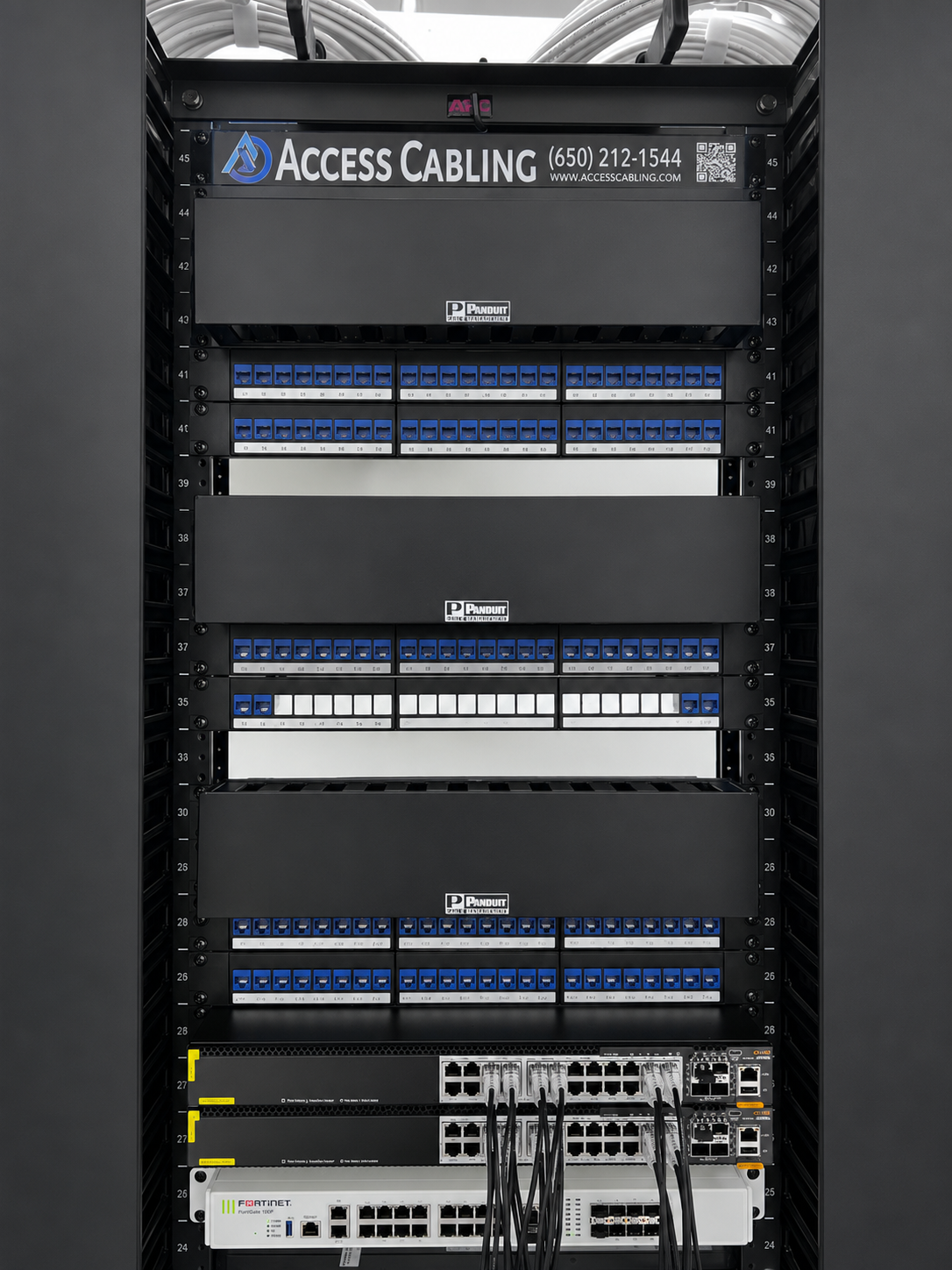 Access Cabling branded network rack with Panduit patch panels, labeled Cat6 ports and Fortinet switches — professional network cabling termination.