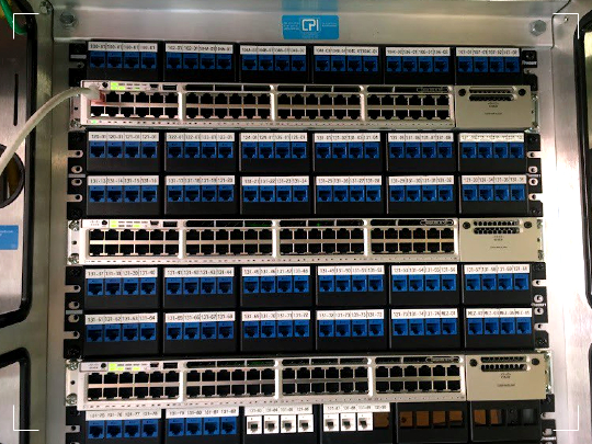 LC fiber patch panel above a Cisco switch inside a Chatsworth (CPI) two-post rack.